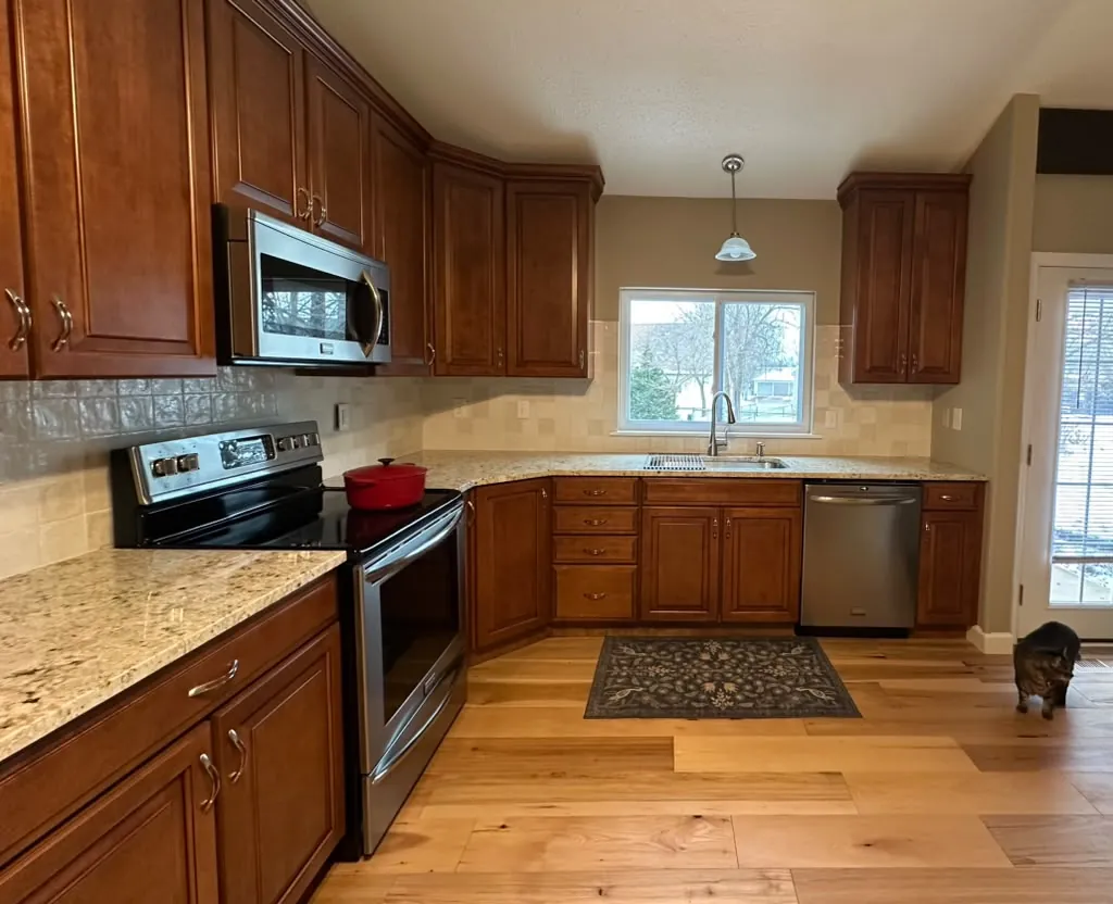 Warm wood kitchen cabinetry and new flooring