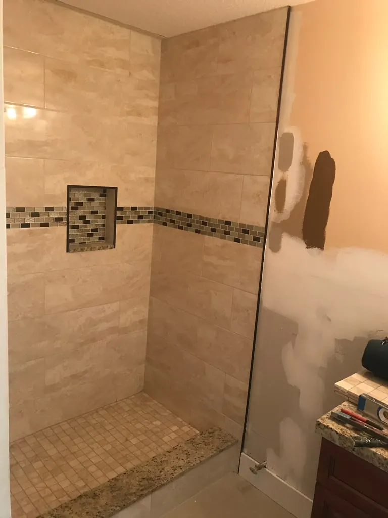 Walk-in shower with mosaic accent and niche