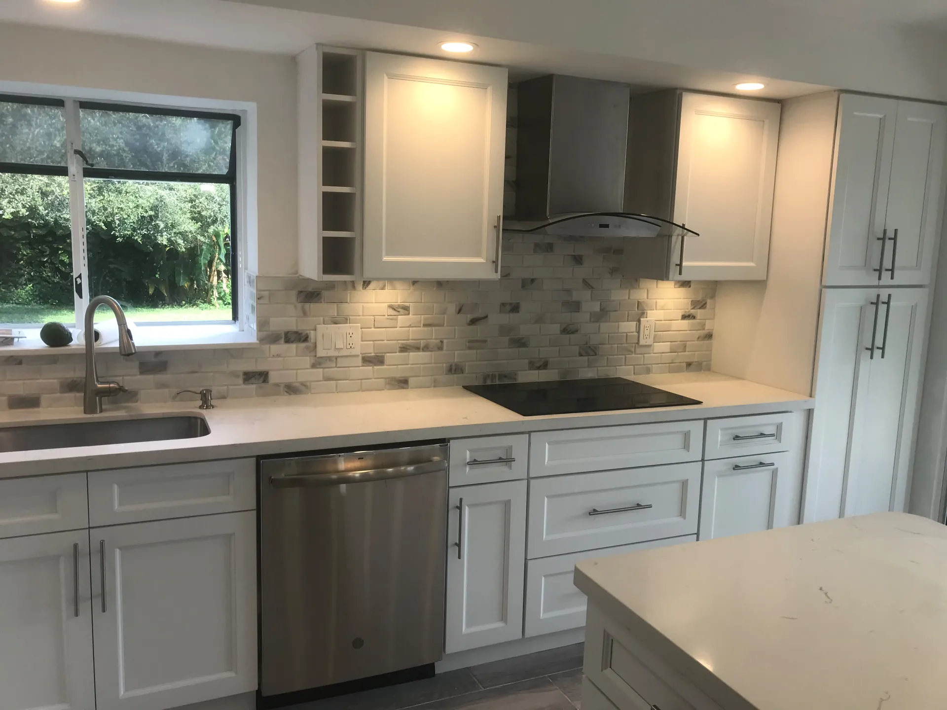 Bright remodeled kitchen with marble backsplash