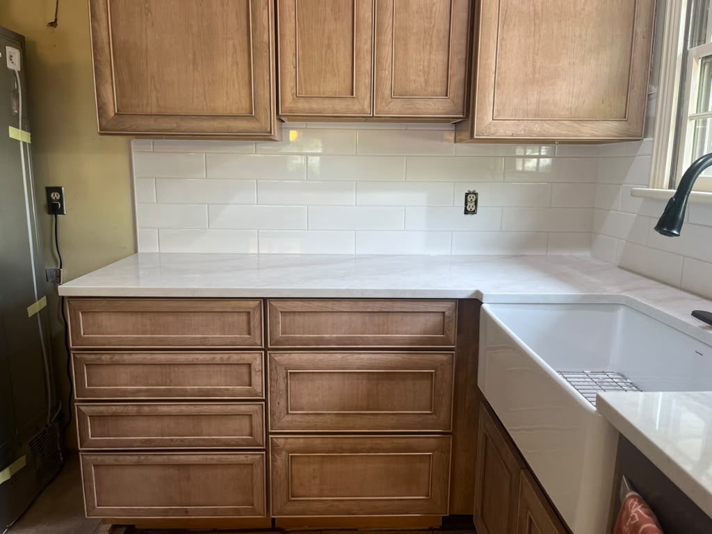 White stone countertop and farmhouse sink remodel