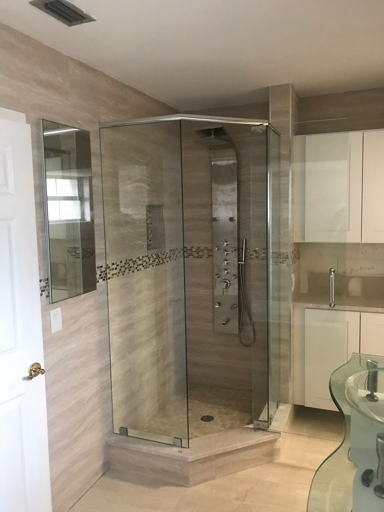 Glass corner shower and custom tile bathroom