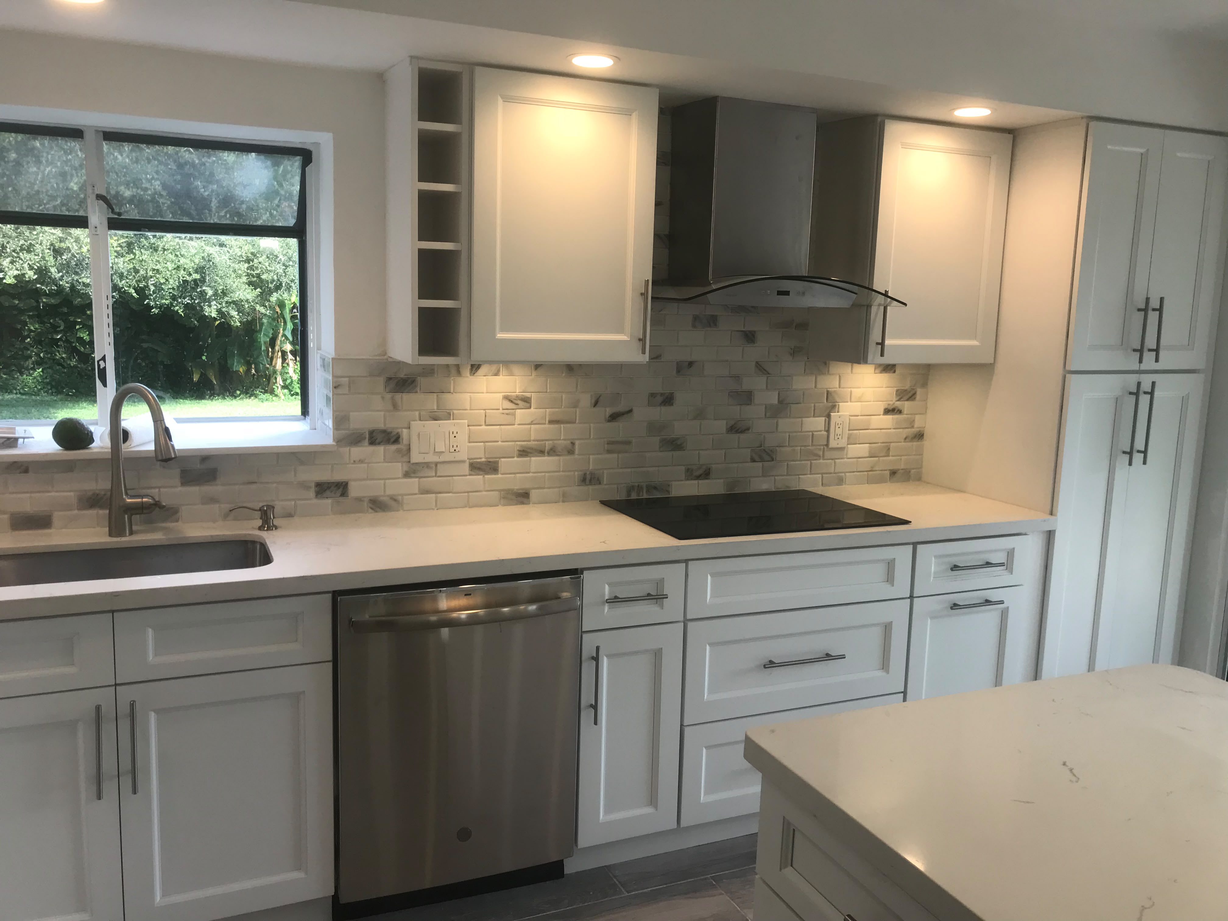 Bright remodeled kitchen with marble backsplash